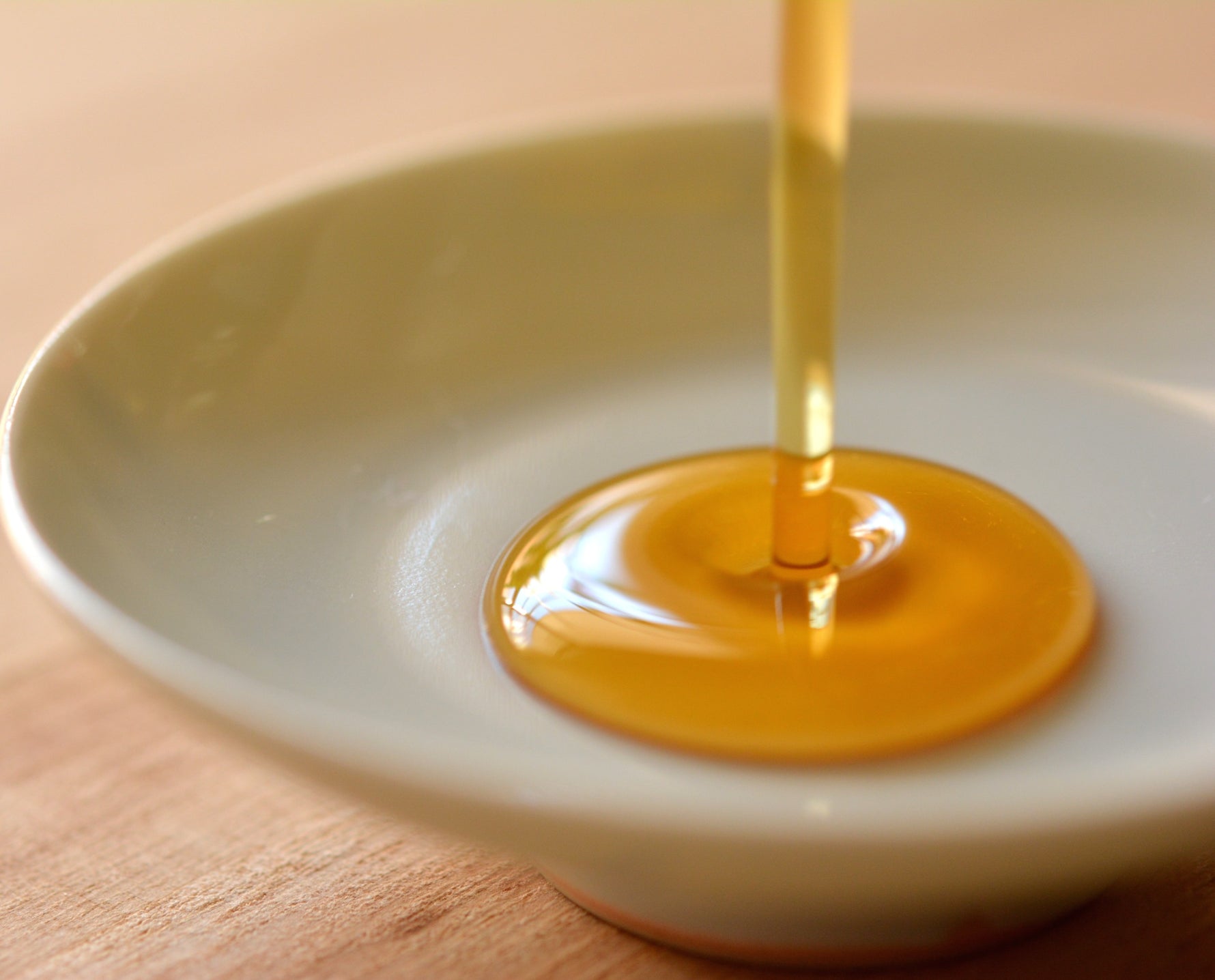 Art of Vedas Ayurvedic Face Oil Serum Nalpamaradi Tailam - Pure Golden Ayurvedic Face Oil Being Poured into Bowl for Skin Brightening and Nourishment